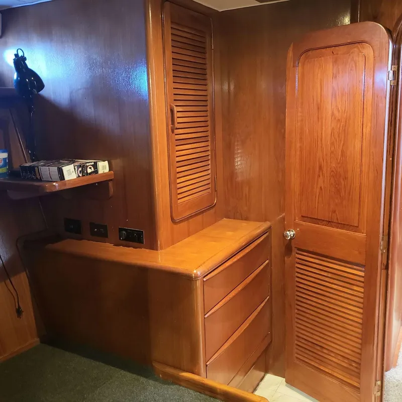 Slide: The Image of Interior of 1988 Viking 55 Motoryacht Walkaround with wooden cabinetry and shelving. - 41