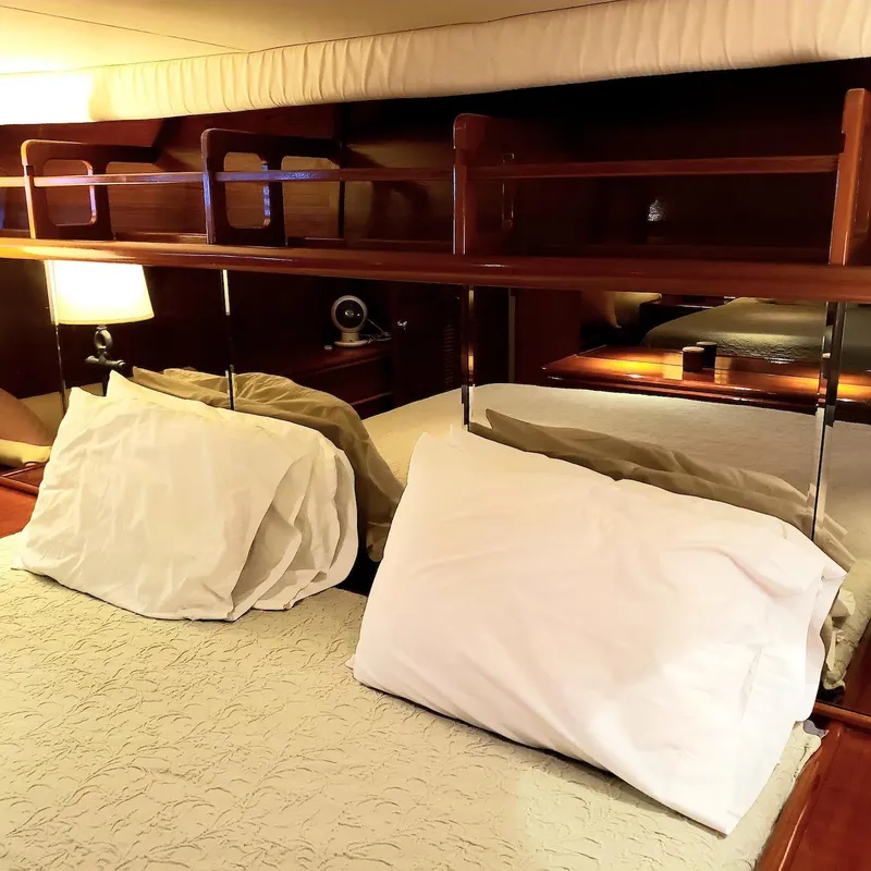 Slide: The Image of Cozy bedroom interior of 1988 Viking 55 Motoryacht Walkaround with pillows and wooden accents. - 42