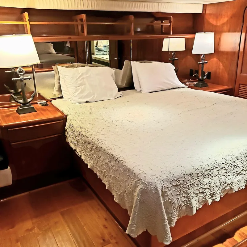 Slide: The Image of Luxurious bedroom interior of 1988 Viking 55 Motoryacht Walkaround with elegant wood finish. - 43