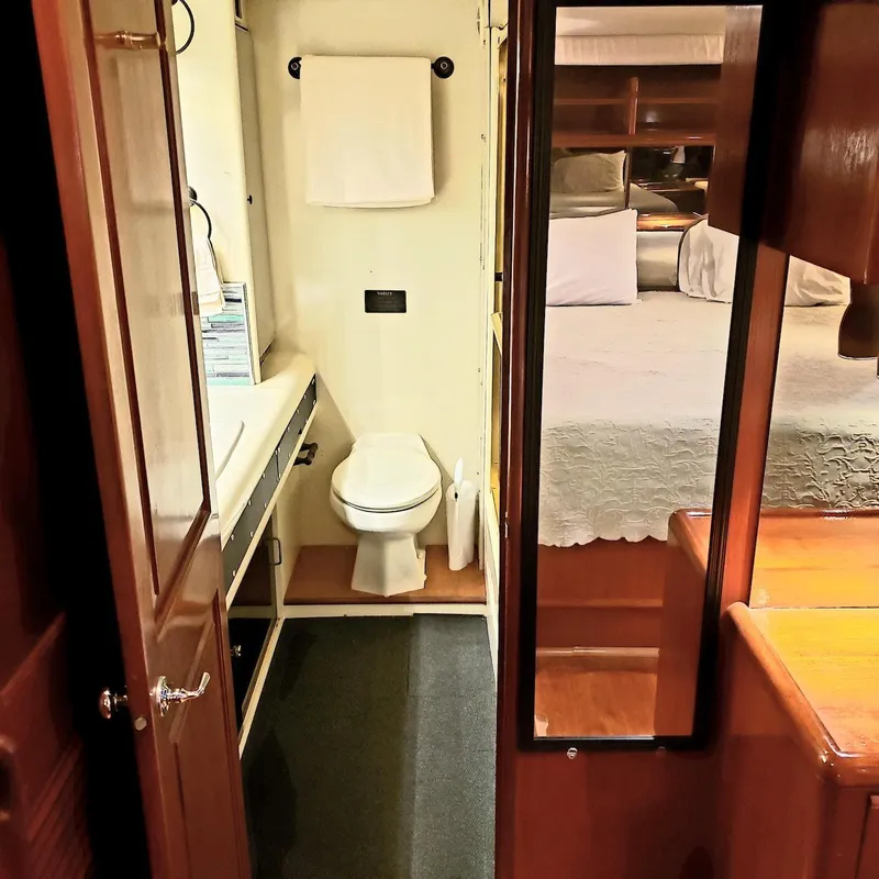 Slide: The Image of 1988 Viking 55 Motoryacht Walkaround interior with bathroom and bedroom view. - 44
