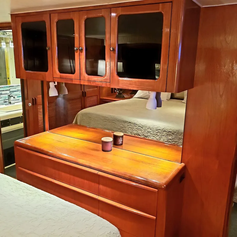 Slide: The Image of Interior of 1988 Viking 55 Motoryacht Walkaround with wooden cabinetry and cozy bedroom. - 45