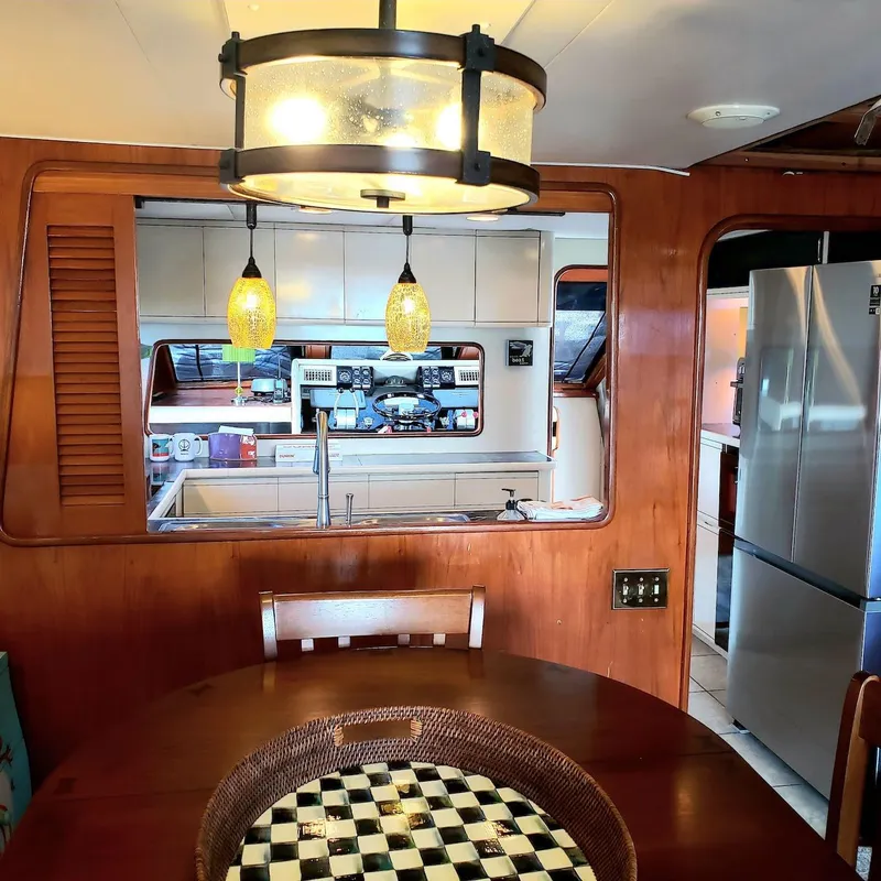 Slide: The Image of Interior of 1988 Viking 55 Motoryacht Walkaround with dining area and kitchen view. - 46