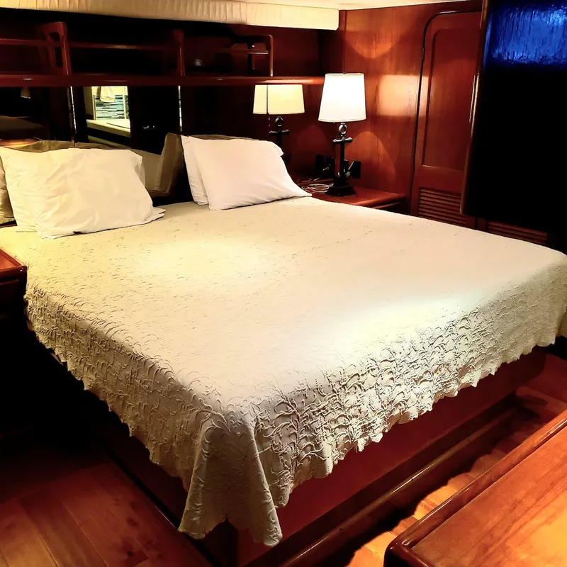 Slide: The Image of Luxurious bedroom interior of 1988 Viking 55 Motoryacht Walkaround with elegant bedding and warm lighting. - 47
