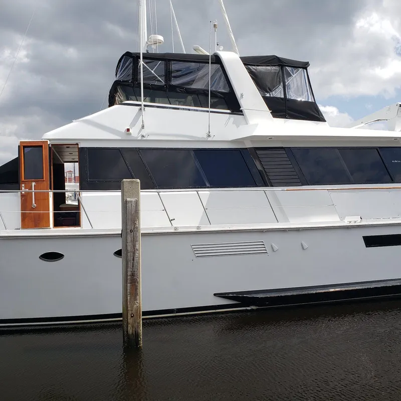 Slide: The Image of 1988 Viking 55 Motoryacht Walkaround docked under cloudy skies. - 8