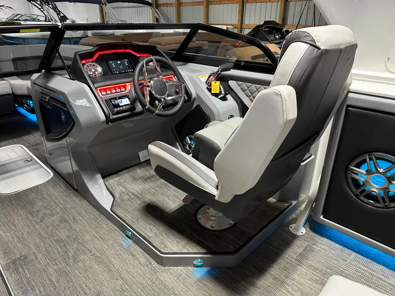 Slide: The Image of 2025 Godfrey AquaPatio 255 SFLW boat interior with modern dashboard and captain's chair. - 20