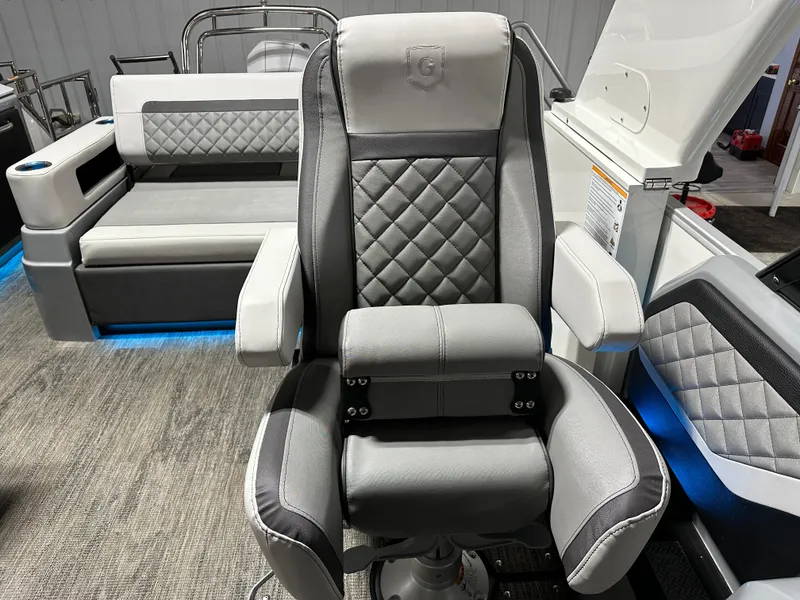 Slide: The Image of Captain's chair on 2025 Godfrey AquaPatio 255 SFLW pontoon boat, featuring luxurious gray upholstery. - 23