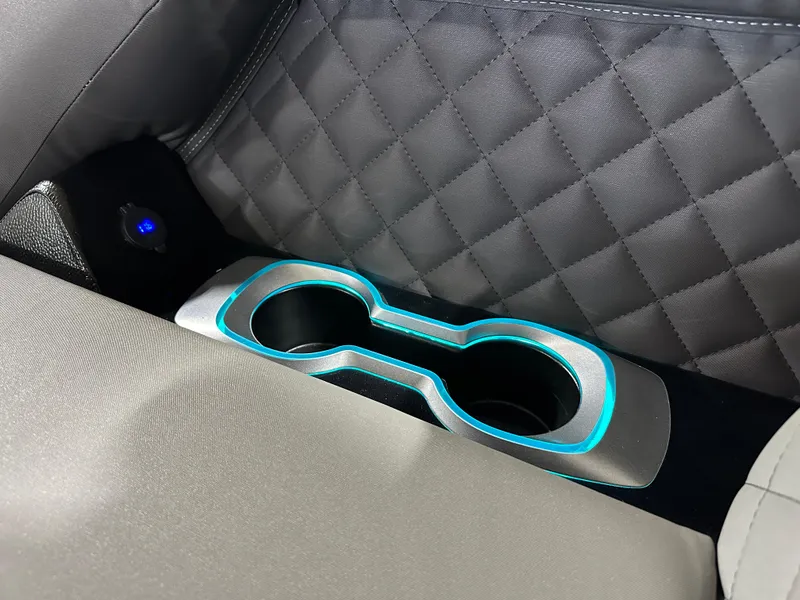 Slide: The Image of Cup holders with blue LED lighting in 2025 Godfrey AquaPatio 255 SFLW boat interior. - 26