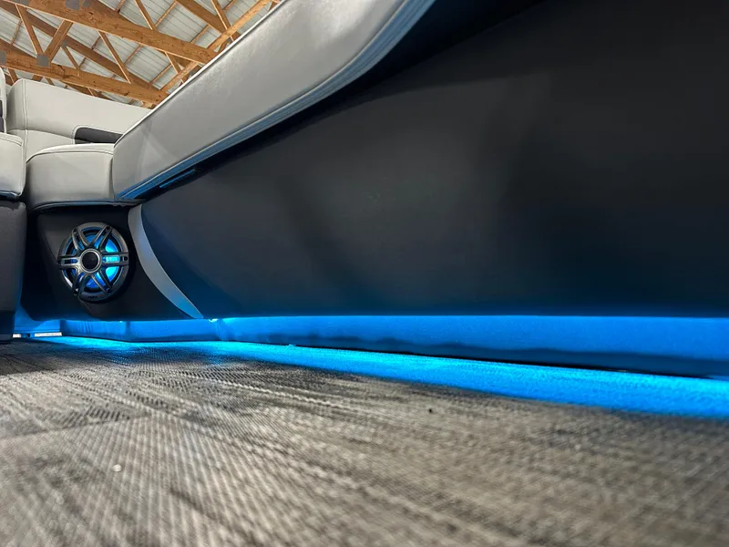 Slide: The Image of 2025 Godfrey AquaPatio 255 SFLW interior with blue LED lighting and speaker detail. - 27