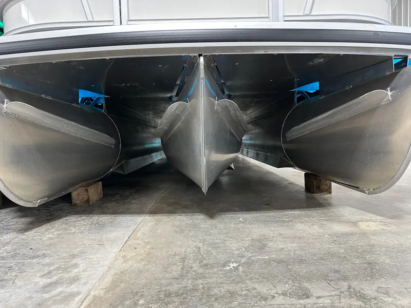 Slide: The Image of Underneath view of 2025 Godfrey AquaPatio 255 SFLW pontoon boat on blocks. - 36