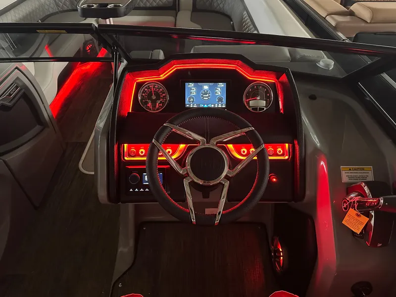 Slide: The Image of 2025 Godfrey AquaPatio 255 SFLW dashboard with illuminated controls and steering wheel. - 38