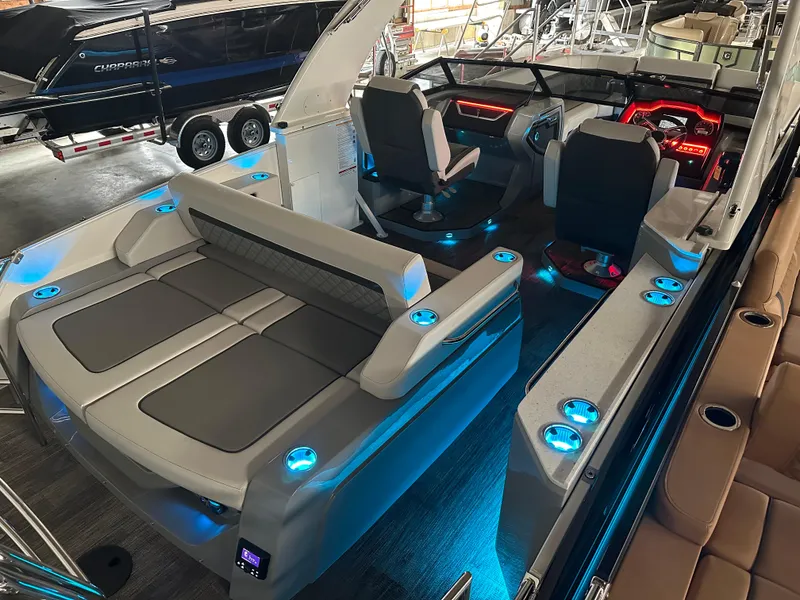 Slide: The Image of 2025 Godfrey AquaPatio 255 SFLW boat interior with illuminated seating and modern dashboard. - 4