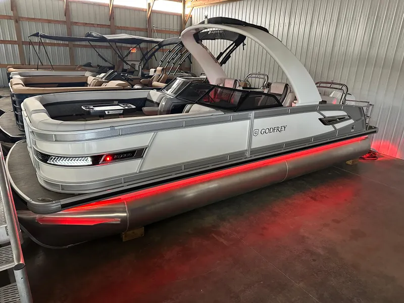Slide: The Image of 2025 Godfrey AquaPatio 255 SFLW pontoon boat with sleek design and red underglow lighting. - 40