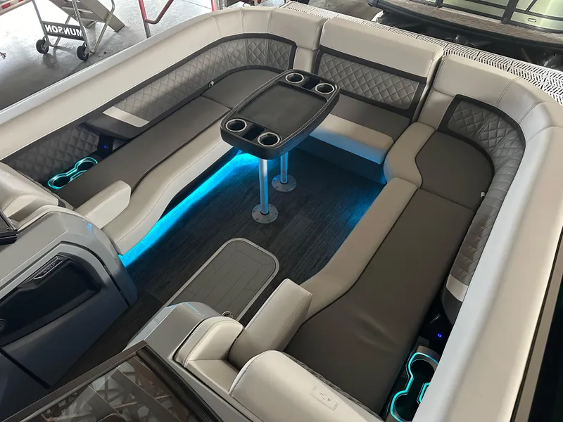 Slide: The Image of 2025 Godfrey AquaPatio 255 SFLW boat interior with LED lighting and seating. - 46