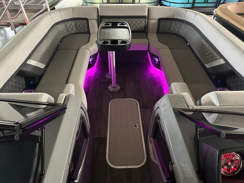 Slide: The Image of 2025 Godfrey AquaPatio 255 SFLW interior with ambient purple lighting and luxurious seating. - 5