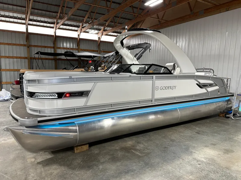 Slide: The Image of 2025 Godfrey AquaPatio 255 SFLW pontoon boat in a storage facility. - 8