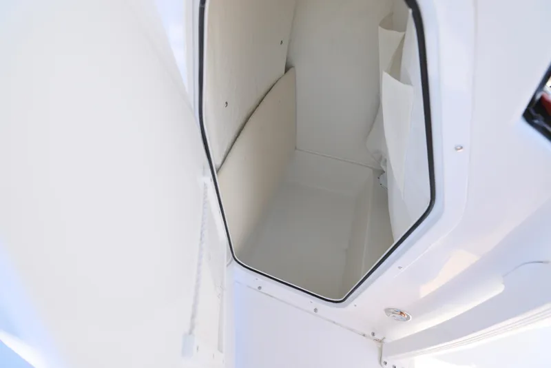 Slide: The Image of Storage compartment of 2025 Sea Hunt Ultra 229 boat, featuring a clean, white interior. - 10