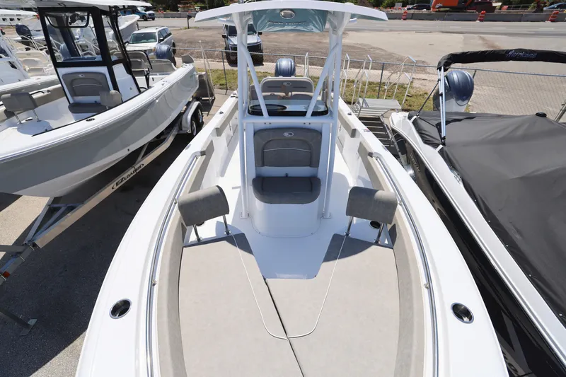 Slide: The Image of 2025 Sea Hunt Ultra 229 boat, sleek design, spacious deck, parked at marina. - 3