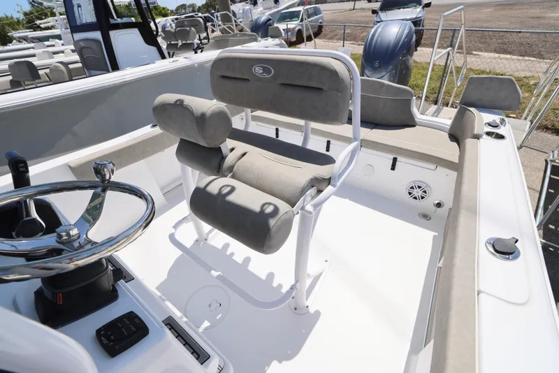 Slide: The Image of 2025 Sea Hunt Ultra 229 boat interior with cushioned seating and steering wheel. - 4