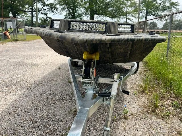 Slide: The Image of 2025 SeaArk 1752 Slayer Pro boat on trailer, featuring LED lights and camouflage design. - 4