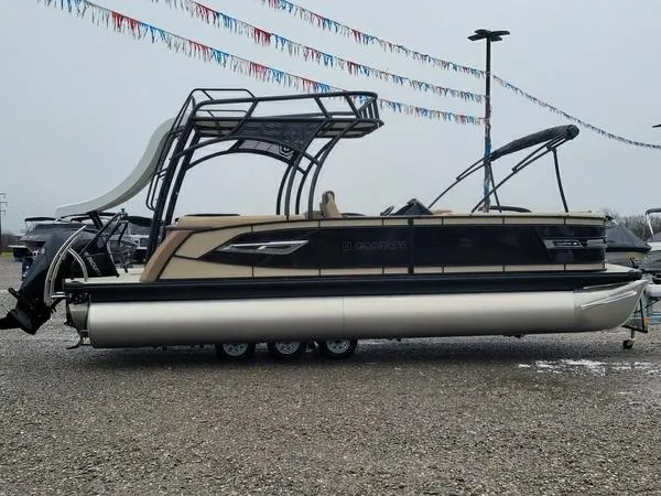 Slide: The Image of 2023 Godfrey Ap255sdc pontoon boat displayed outdoors on gravel lot. - 1