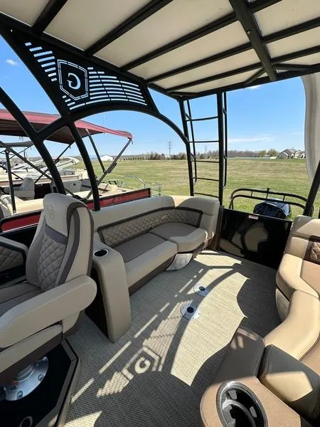 Slide: The Image of 2023 Godfrey Ap255sdc boat interior with luxurious seating and open canopy design. - 11