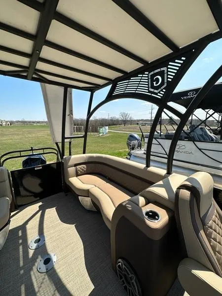 Slide: The Image of 2023 Godfrey Ap255sdc boat interior with cushioned seating and canopy. - 13