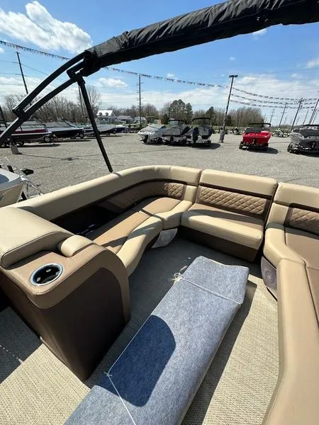 Slide: The Image of 2023 Godfrey Ap255sdc boat interior with tan seating and cup holders. - 17