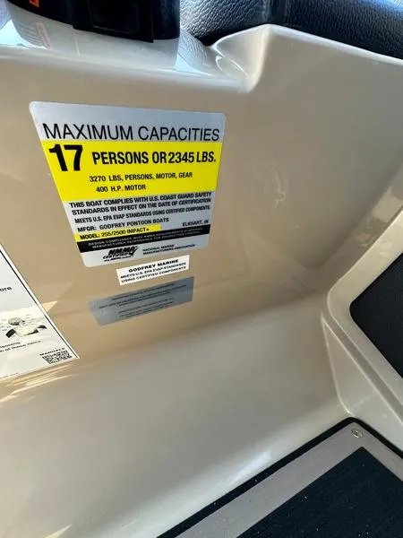 Slide: The Image of Capacity label on 2023 Godfrey Ap255sdc boat, showing limits for persons and weight. - 18