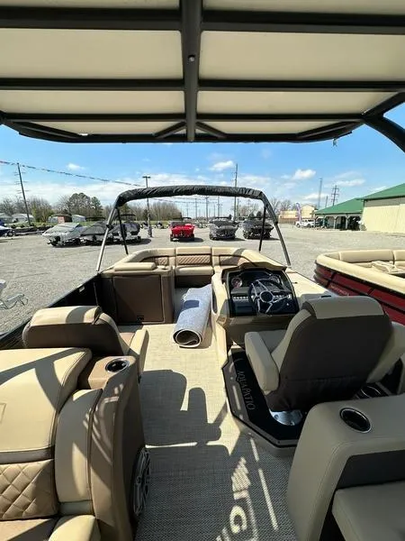 Slide: The Image of 2023 Godfrey Ap255sdc boat interior with beige seating and steering console. - 8
