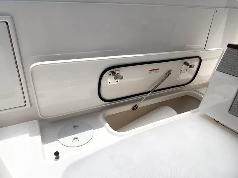 Slide: The Image of 2023 Tiara Yachts 38 LS storage compartment with hydraulic lift and sleek design. - 14