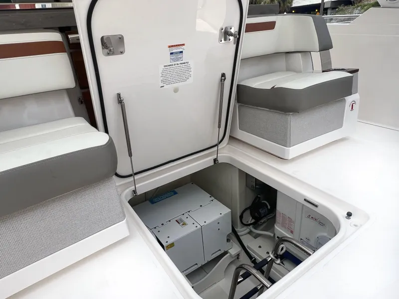Slide: The Image of 2023 Tiara Yachts 38 LS interior with open hatch revealing storage compartment. - 18