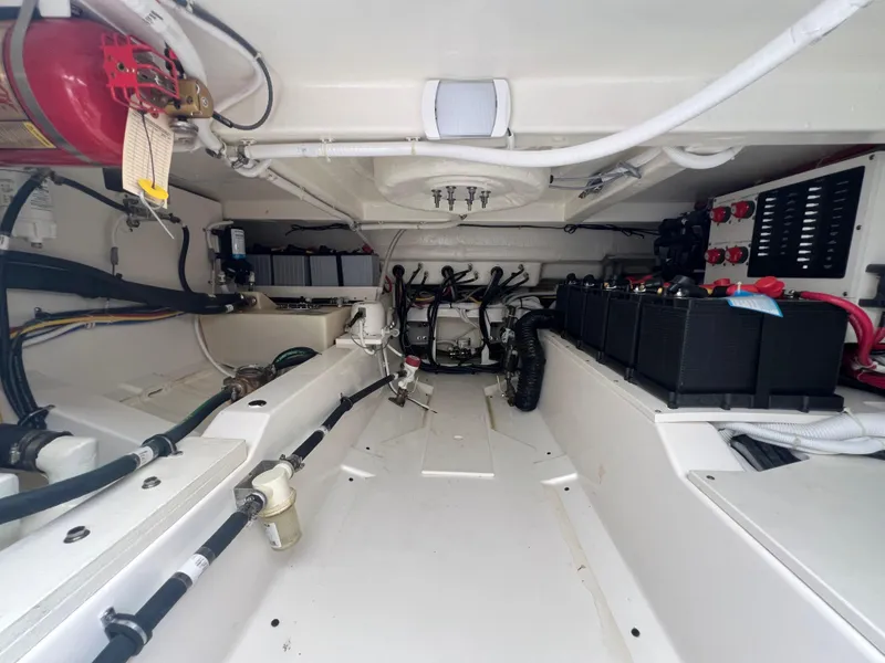 Slide: The Image of Engine compartment of 2023 Tiara Yachts 38 LS, showcasing wiring and battery systems. - 21