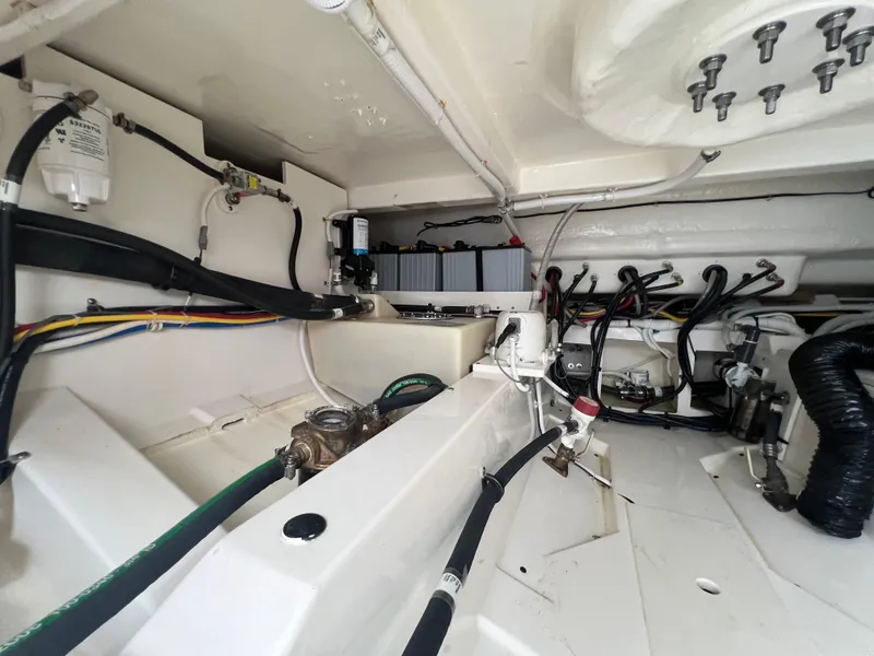 Slide: The Image of Engine compartment of 2023 Tiara Yachts 38 LS, showcasing wiring and mechanical components. - 24