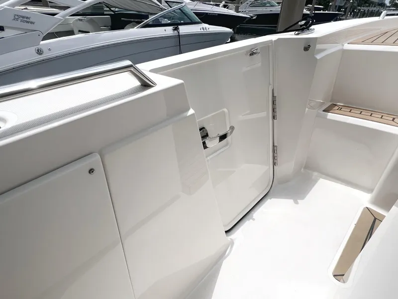 Slide: The Image of 2023 Tiara Yachts 38 LS boat interior with sleek white design and seating area. - 26