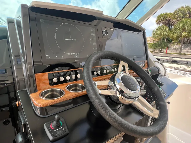 Slide: The Image of 2023 Tiara Yachts 38 LS helm with modern controls and navigation displays. - 29