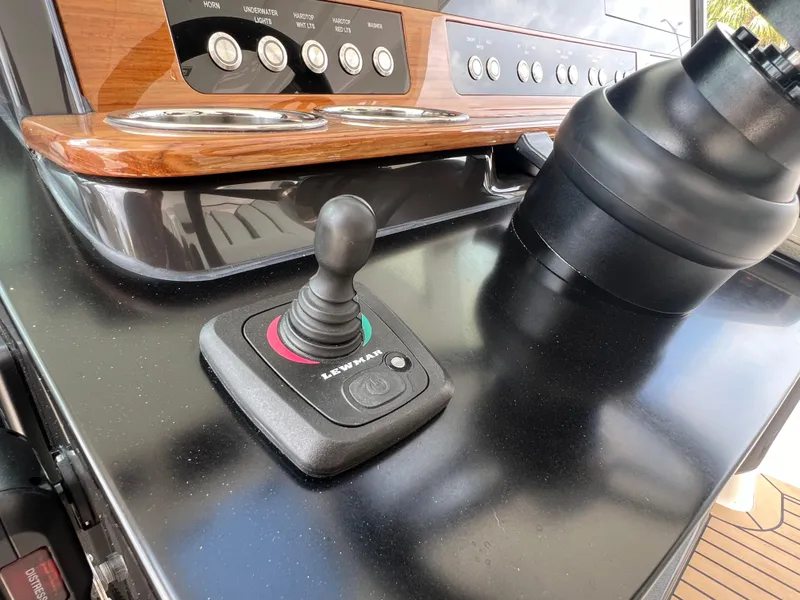 Slide: The Image of Joystick control on 2023 Tiara Yachts 38 LS dashboard with wood accents. - 32