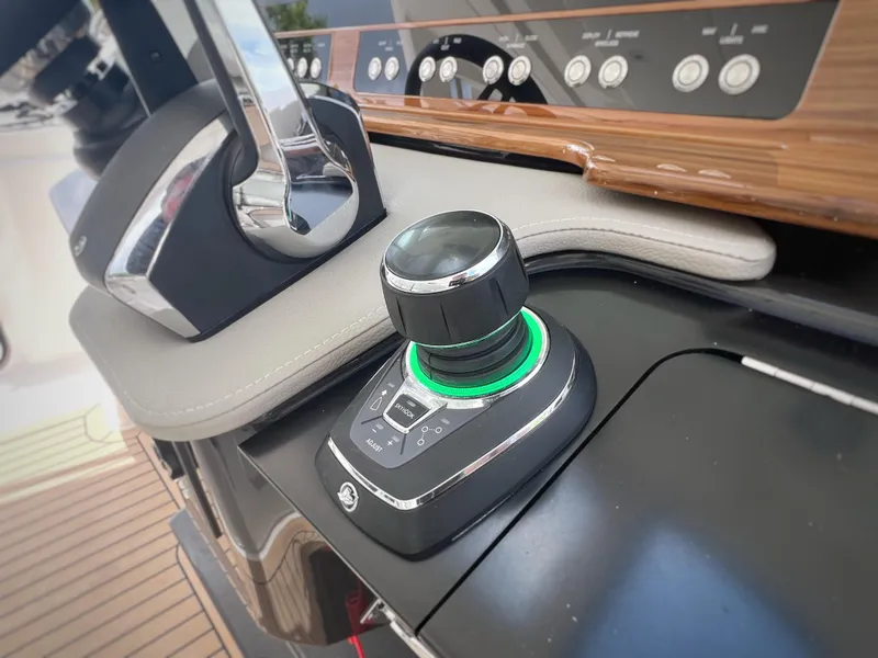 Slide: The Image of 2023 Tiara Yachts 38 LS helm control with joystick and modern dashboard. - 34