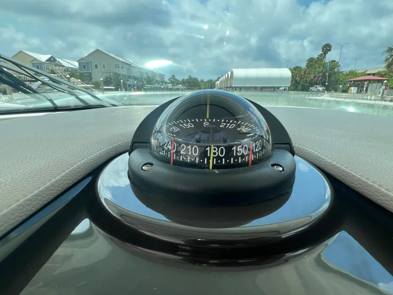 Slide: The Image of Compass on 2023 Tiara Yachts 38 LS dashboard with scenic marina view. - 35