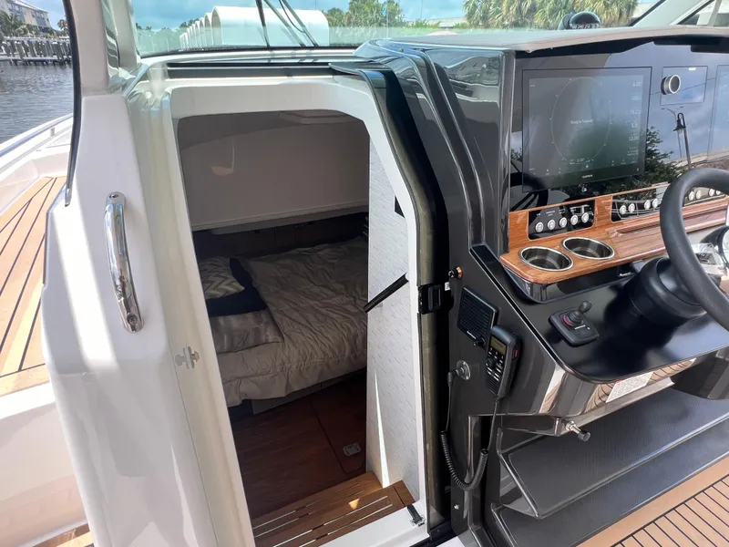 Slide: The Image of 2023 Tiara Yachts 38 LS cabin interior with helm and cozy sleeping area. - 36
