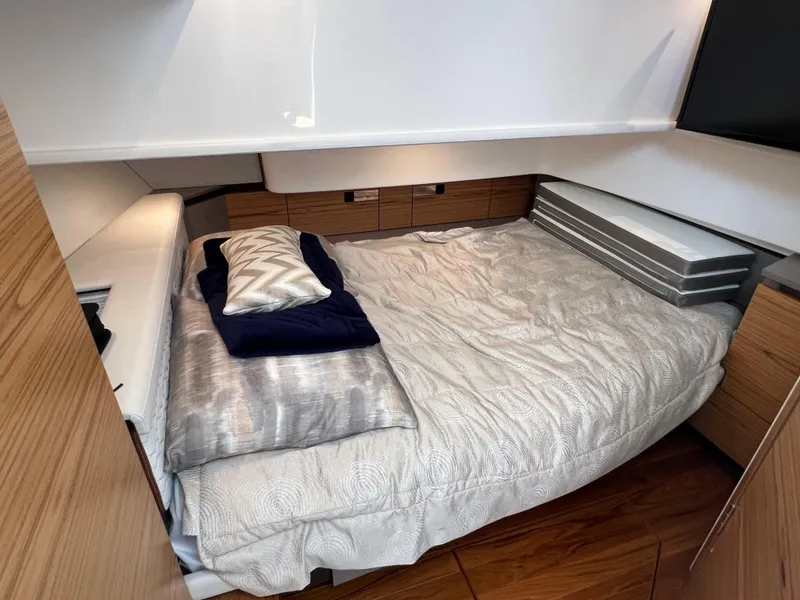 Slide: The Image of 2023 Tiara Yachts 38 LS cabin interior with cozy bed and modern wood finish. - 37