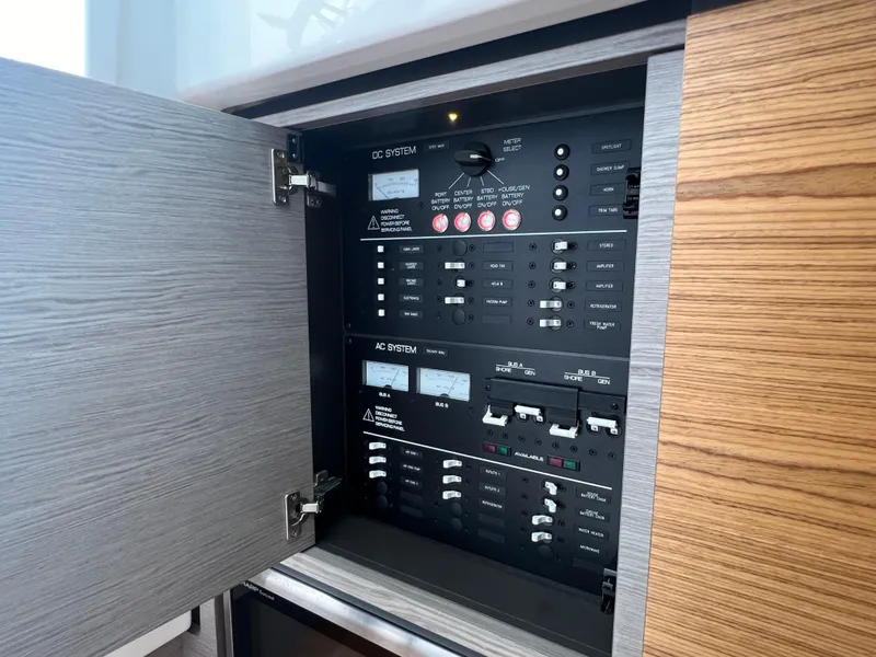 Slide: The Image of Electrical panel inside 2023 Tiara Yachts 38 LS, showcasing control switches and circuit breakers. - 39