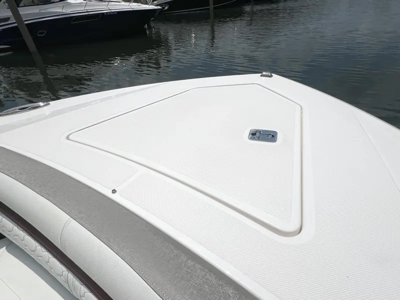 Slide: The Image of 2023 Tiara Yachts 38 LS bow deck, sleek design, docked on calm water. - 48