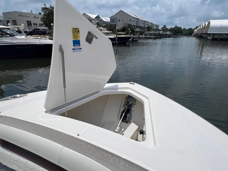 Slide: The Image of 2023 Tiara Yachts 38 LS with open storage compartment, docked in a marina. - 49