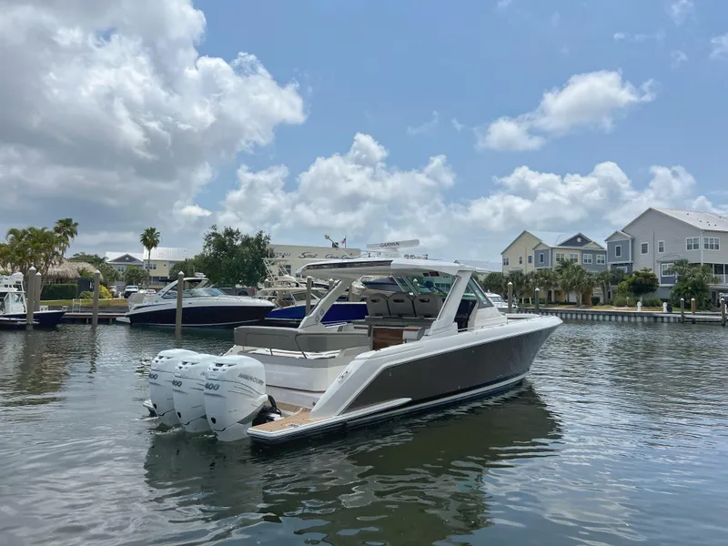 Slide: The Image of 2023 Tiara Yachts 38 LS in marina, showcasing sleek design and powerful engines. - 5