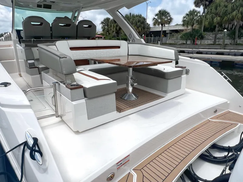 Slide: The Image of 2023 Tiara Yachts 38 LS luxury boat with elegant seating and wooden table. - 7