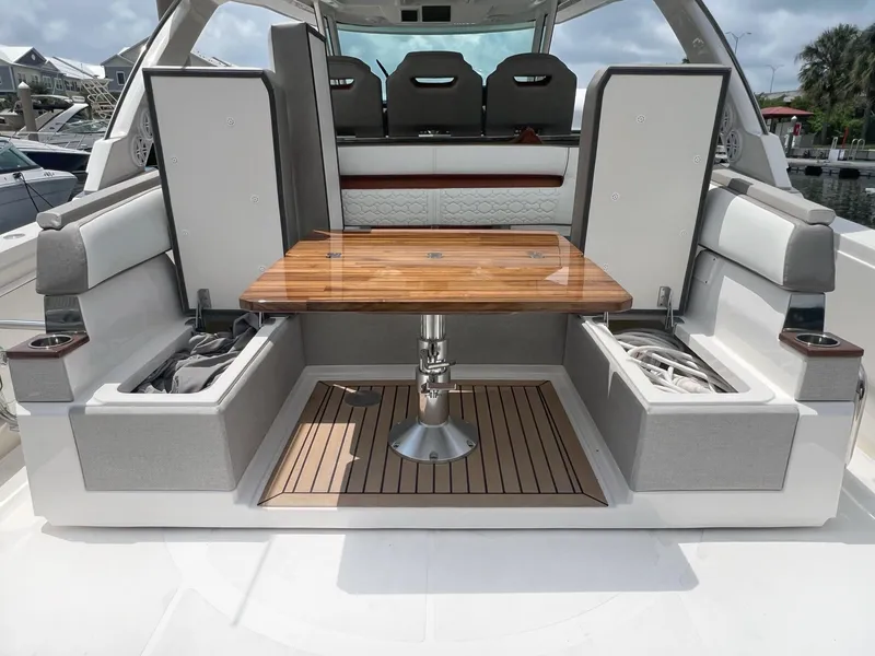 Slide: The Image of 2023 Tiara Yachts 38 LS interior with wooden table and cushioned seating. - 8