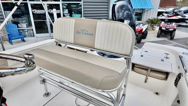 Slide: The Image of 2018 Sea Chaser LX 21 boat interior with beige seating and steering wheel. - 12