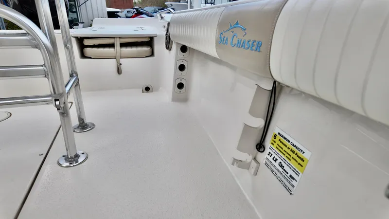 Slide: The Image of 2018 Sea Chaser LX 21 boat interior with seating and safety label. - 13