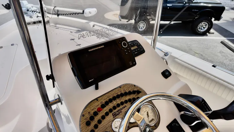 Slide: The Image of 2018 Sea Chaser LX 21 boat dashboard with steering wheel and navigation equipment. - 15