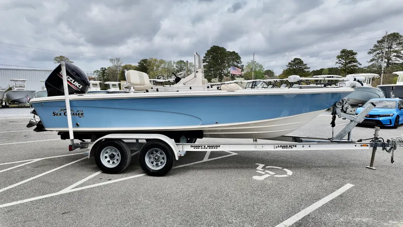 Slide: The Image of 2018 Sea Chaser LX 21 boat on trailer in parking lot, cloudy sky background. - 4